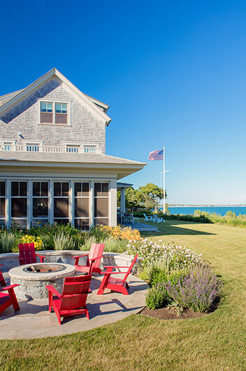 Outfoor firepit with adirondack chairs in backyard